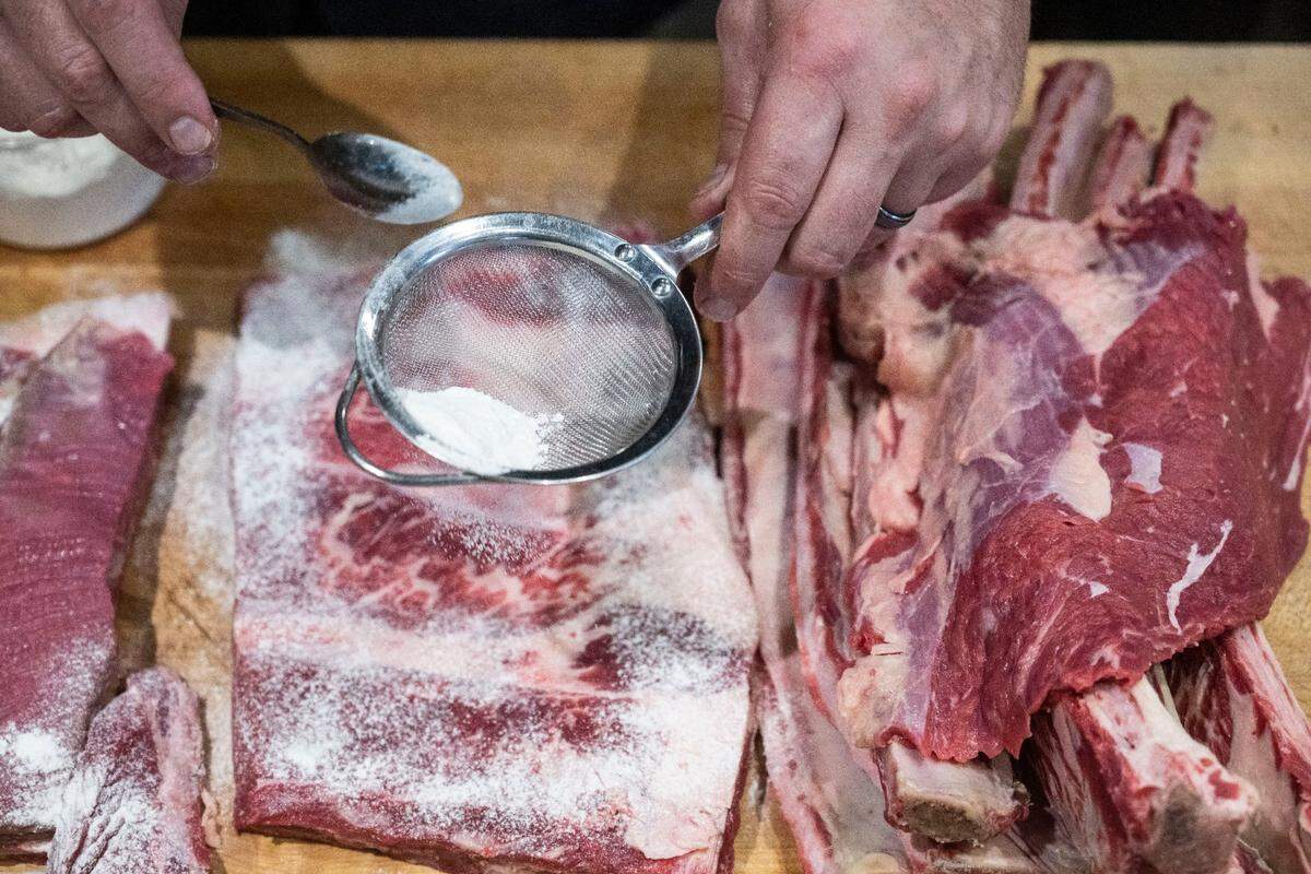 Localis chef-owner Chris Barnum-Dann seasons ribs last Friday. His restaurant’s Michelin star is one of only 89 in the entire state.