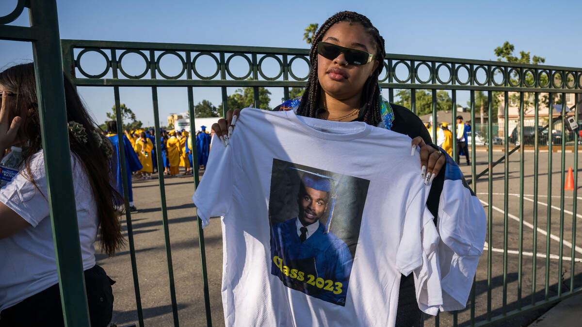 Jianna Smith, a 2022 John F. Kennedy High School graduate, holds a shirt dedicated to Billy Scott before the Grant Union High School graduation ceremony Thursday, June 1, 2023, in Sacramento’s Del Paso Heights neighborhood. Scott, an 18-year-old senior set to graduate, was killed in a North Highlands shooting the night before, authorities said.