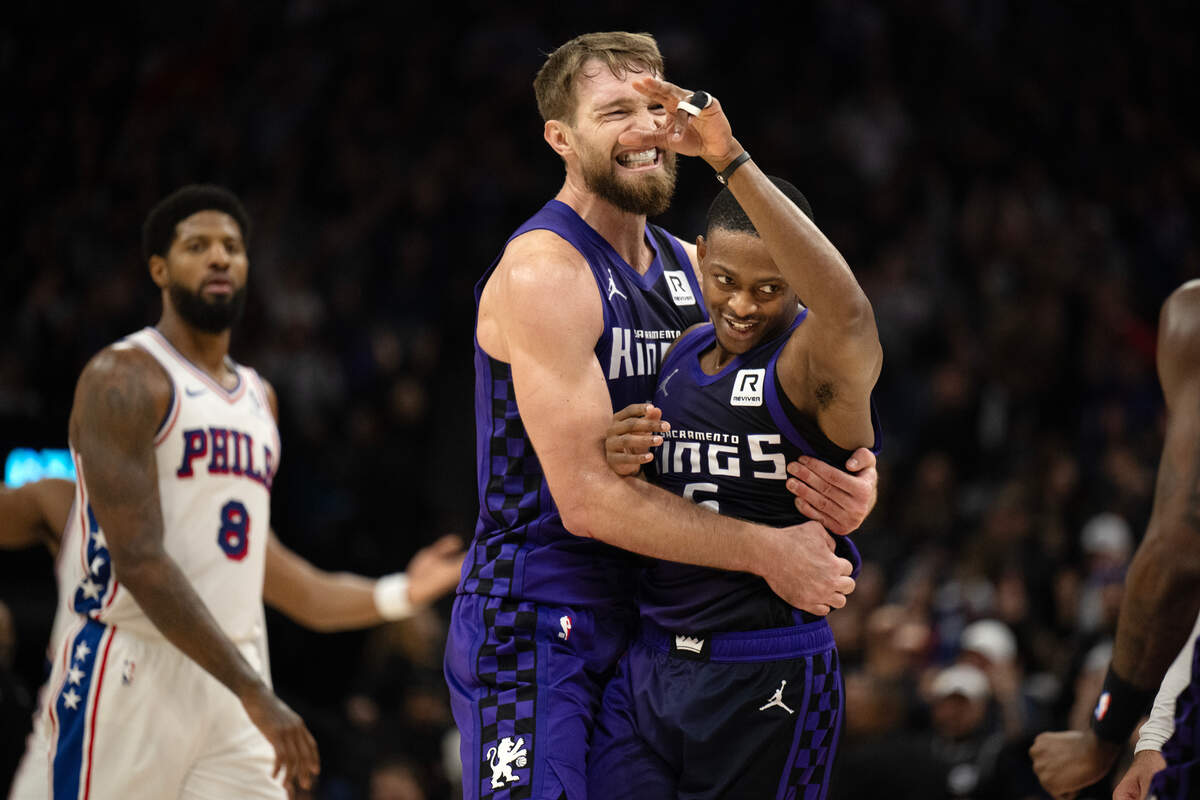 Sacramento Kings center Domantas Sabonis (11) embraces teammate, guard De’Aaron Fox (5) after Fox made a three point shot at the end of the first half against th Philadelphia 76ers on Wednesday, Jan. 1, 2025 at Golden 1 Center.