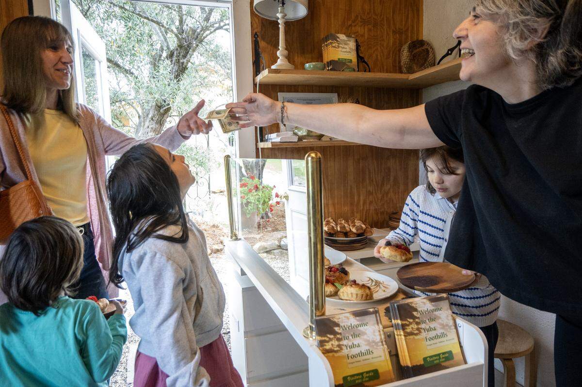 Ana Rodriguez places an order at Artisan Lavinia in Oregon House with her children Alma and Mateo on May 2.
