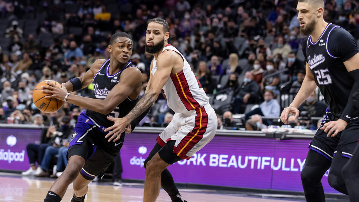 Sacramento Kings guard De’Aaron Fox (5) drives to the basket past Miami Heat forward Caleb Martin (16) to make a fadeaway jump shot during the second quarter on Sunday, Jan. 2, 2022 during an NBA basketball game at the Golden 1 Center in Sacramento.