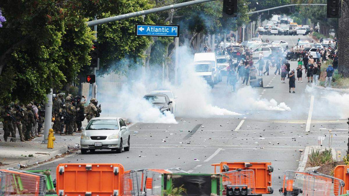 People block off the street and set a fire during protests against ICE and immigration raids on Saturday, June 7, 2025, in Paramount. Gov. Gavin Newsom condemned the federal deployment of National Guard troops to the area. 
