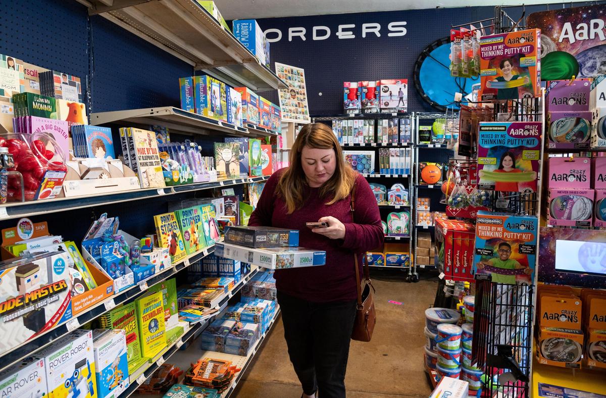 Jennifer Opie, who lives in Oak Park, finds puzzles and games for her children at East Sac Hardware on Saturday, March 28, 2020, after not finding what she wanted at bigger stores in Sacramento. “We’re doing okay, it’s not that much different,” she said regarding schools closing to address the new coronavirus. “We’re homeschoolers, so for us it’s been pretty much same old.”