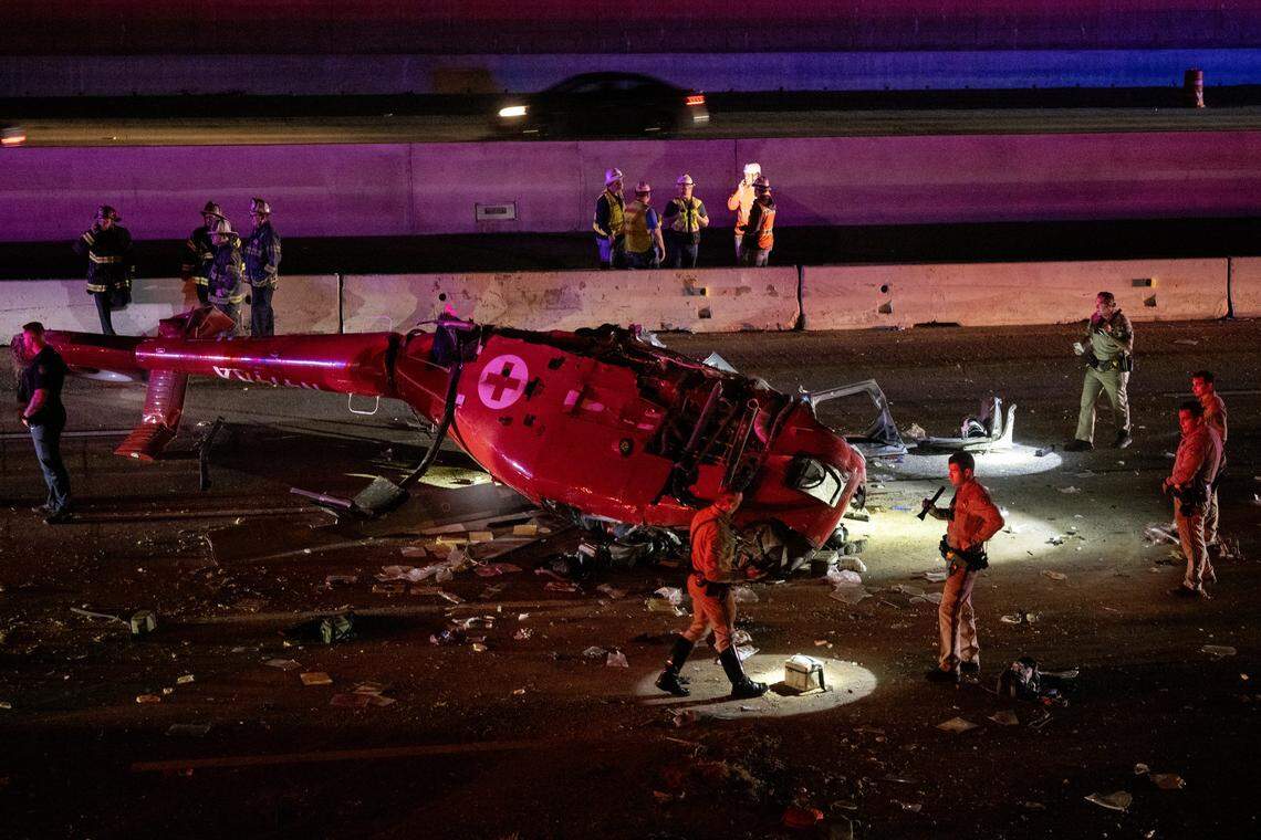 A medevac helicopter with three people crashed on eastbound Highway 50 near 44th Street on Monday, Oct. 6, 2025, in Sacramento. The aircraft was split down the middle — exposing its bungled interior — as CHP investigators used flashlights along the shoulder, searching for debris.
