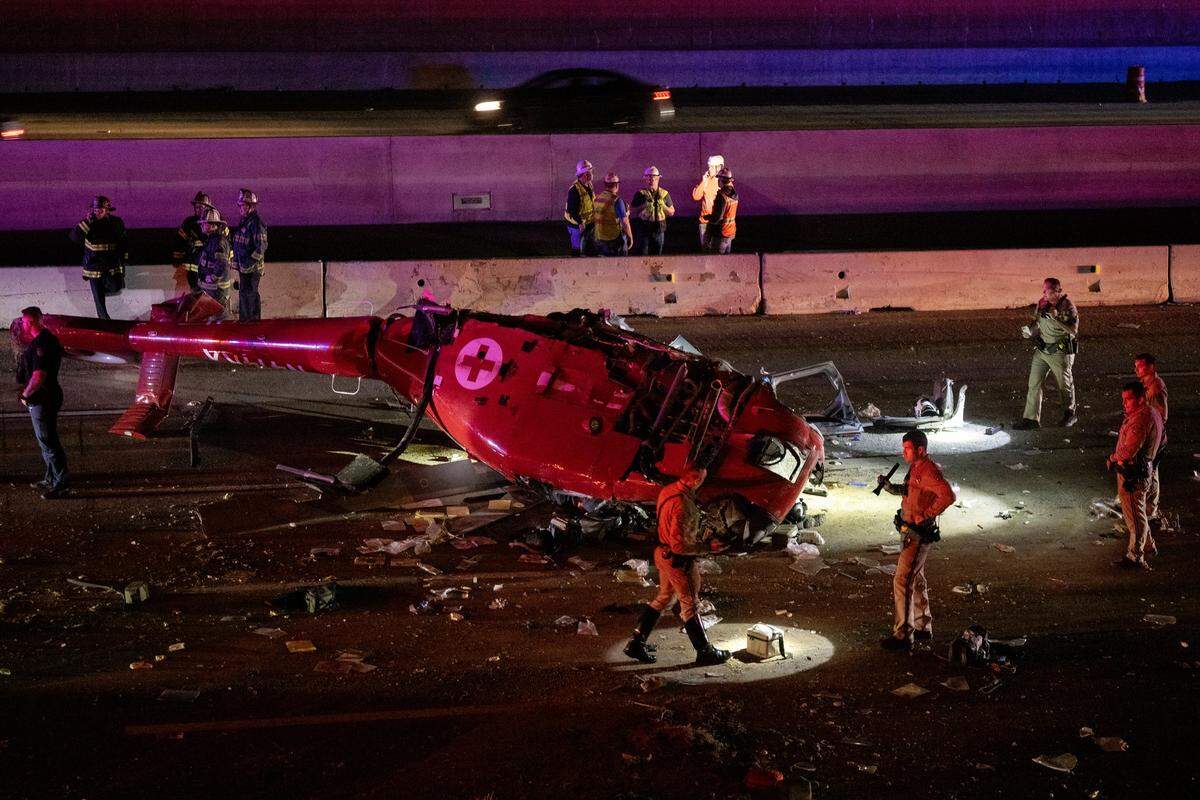 A medevac helicopter with three people crashed Monday night on eastbound Highway 50 near 44th Street in Sacramento. The aircraft was split down the middle — exposing its damaged interior — as CHP investigators used flashlights along the shoulder, searching for debris.