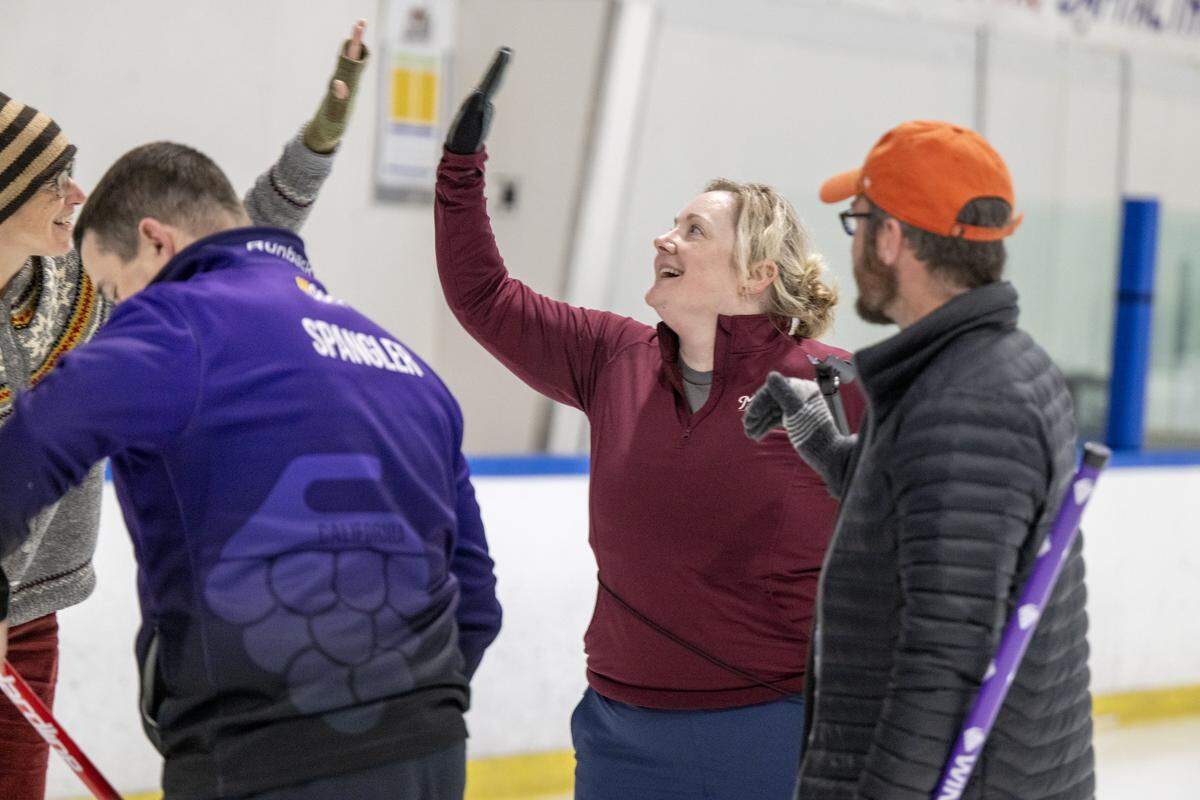 Patricia Dickerson celebrates with teammates after a win during a match earlier this month at Skatetown Ice Arena in Roseville.
