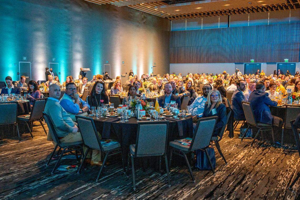 State of Downtown breakfast attendees listen to speakers on Tuesday at the SAFE Sacramento Convention Center. The event was an opportunity for vaccinated members of the downtown community to meet with in-person indoors without masks.
