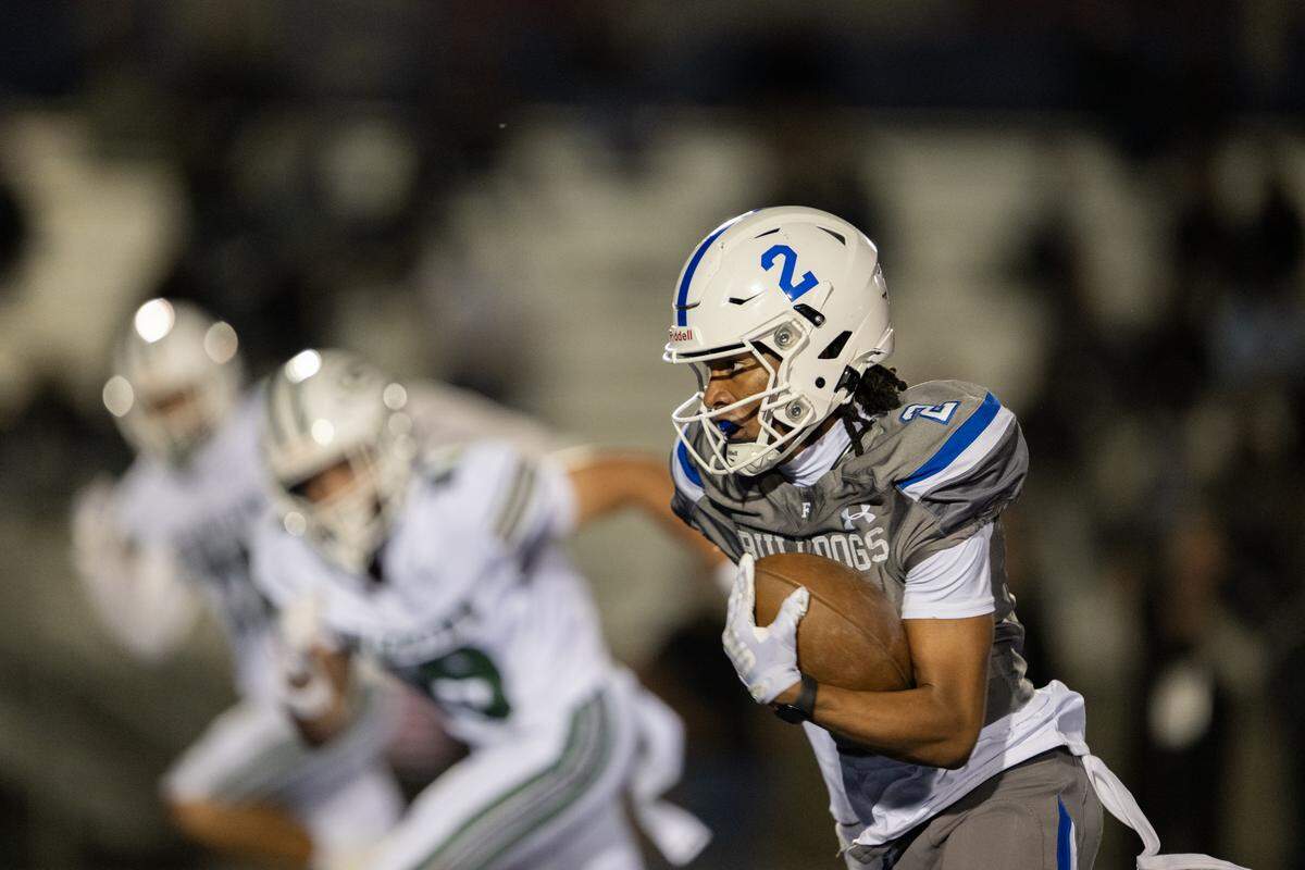 The Folsom Bulldogs’ Jameson Powell (2) takes a pass for a touchdown In the first half against the Granite Bay Grizzlies on Friday in Folsom.