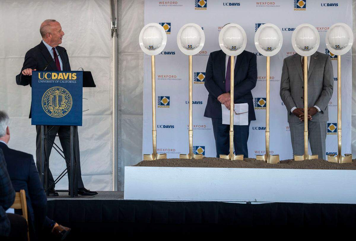 Sacramento Mayor Darrell Steinberg speaks about the Aggie Square project during a ceremonial ground breaking Feb. 16, 2022, at the UC Davis Medical Center campus in Sacramento. Behind the shovels are Doug Woodruff, senior director of new business development at Wexford Science and Technology and UC Davis Chancellor Gary May.