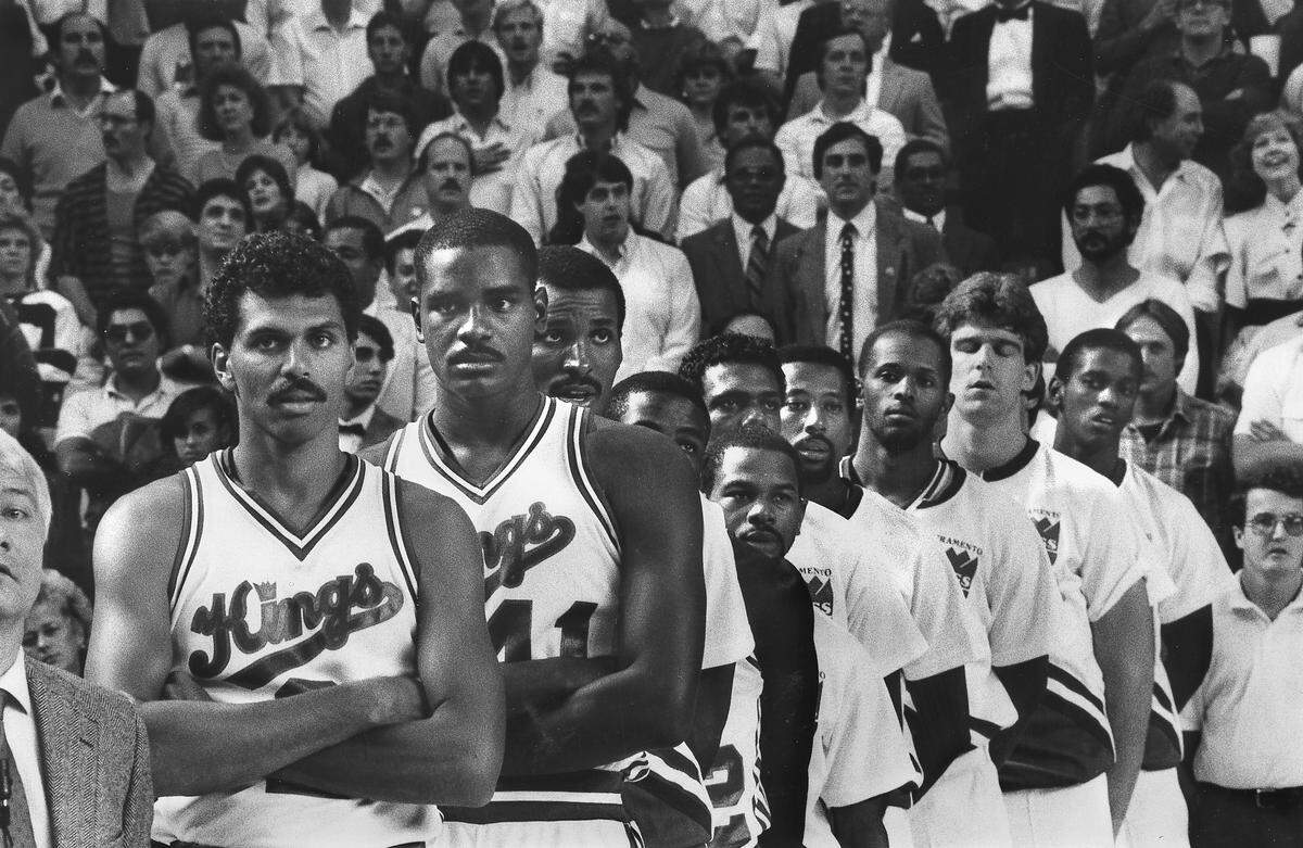Members of the Sacramento Kings line up for the opening ceremonies for the first game for the franchise in Sacramento on Oct. 25, 1985. Players from left: Reggie Theus, LaSalle Thompson, Eddie Johnson, Larry Drew, Michael Adams, Carl Henry, Mike Woodson, David Cooke, Joe Kleine and Otis Thorpe.