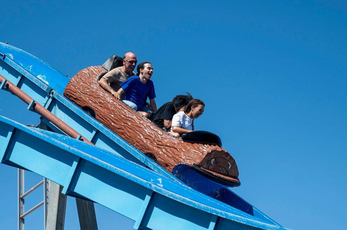 Duncan Cameron, left, of West Sacramento; Johnathan Cameron, second to left, 15; Jayda Reichling, 17; and Camille Cameron, 17; scream as they are about to be splashed on the White Water ride at the California State Fair in 2022.