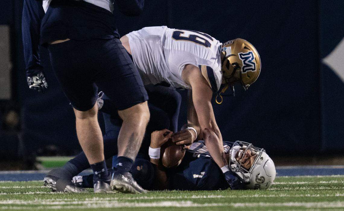 UC Davis Aggies quarterback Miles Hastings (7) is taken down by Montana State Bobcats linebacker Neil Daily (19) on Saturday.
