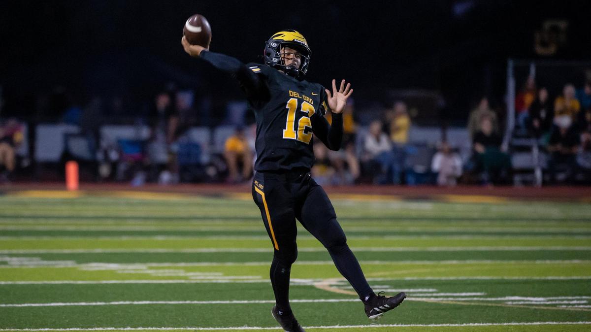 Del Oro quarterback Caden Pinnick (12) throws a touchdown pass to Tommy Poe (13) during the first quarter in the game against the Menlo-Atherton Bears on Friday, Sept. 16, 2022, at Del Oro High School in Loomis.
