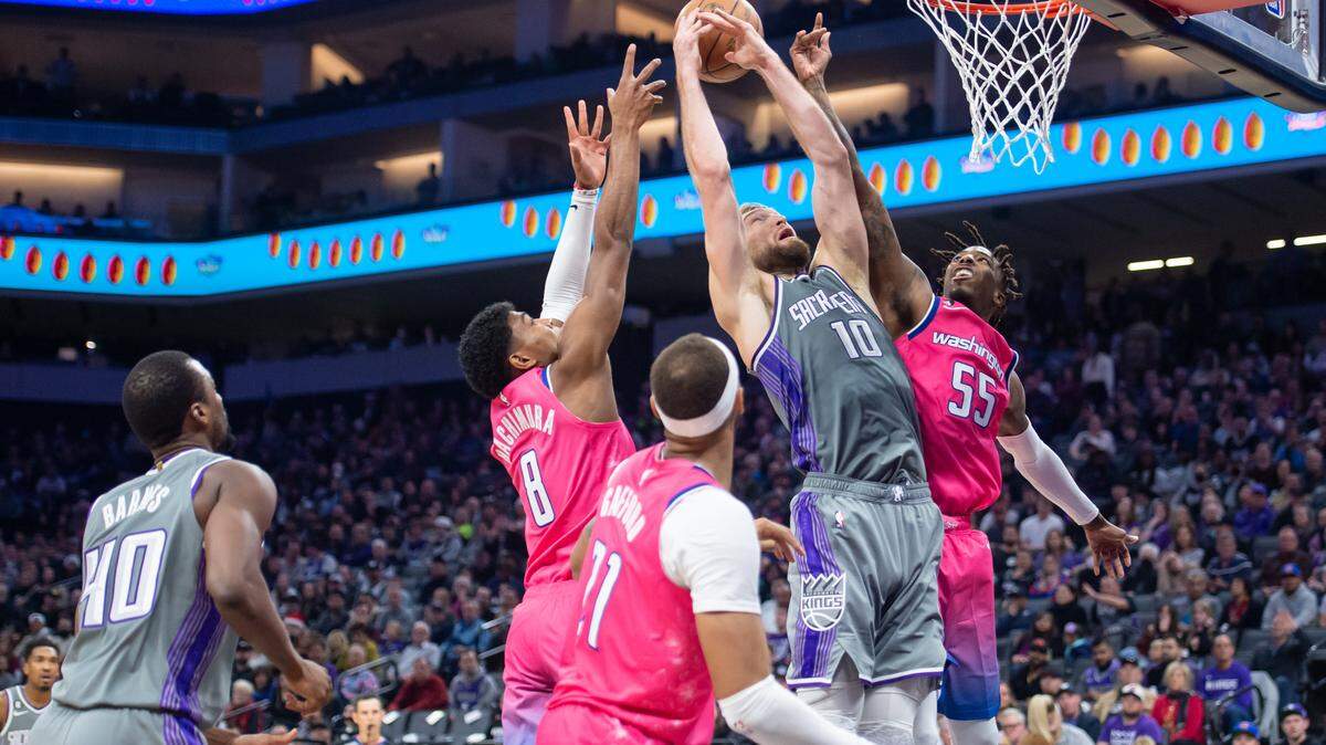 Sacramento Kings forward Domantas Sabonis (10) goes up for a rebound surrounded by Washington Wizards defenders during the second half in the NBA basketball game Friday at Golden 1 Center. The Wizards won 125-111.