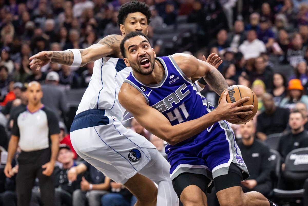 Sacramento Kings forward Trey Lyles (41), right, goes up for two points and is fouled by Dallas Mavericks forward/center Christian Wood (35) during the second quarter of the NBA basketball game Saturday, Feb. 11, 2023, at Golden 1 Center in Sacramento.
