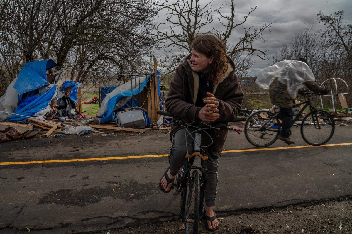 Christina Qualls said her dog was okay but her street dad’s tent was damaged badly by a big tree at a homeless encampment near Basler and N. 18th streets in Sacramento on Wednesday, Jan. 27, 2021.