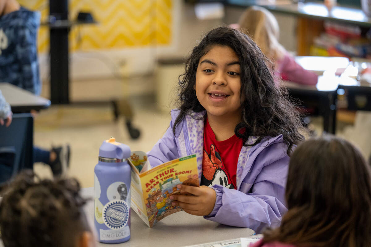 Aaliyah, a student at Cirby Elementary School in Roseville receives a new book provided by the nonprofit My Mother’s Voice, on Friday, November 18, 2022.
