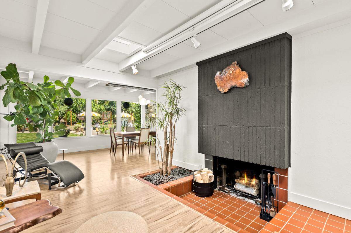 The sunken fireplace and atrium is a charming part of the living room in the Carmichael home.