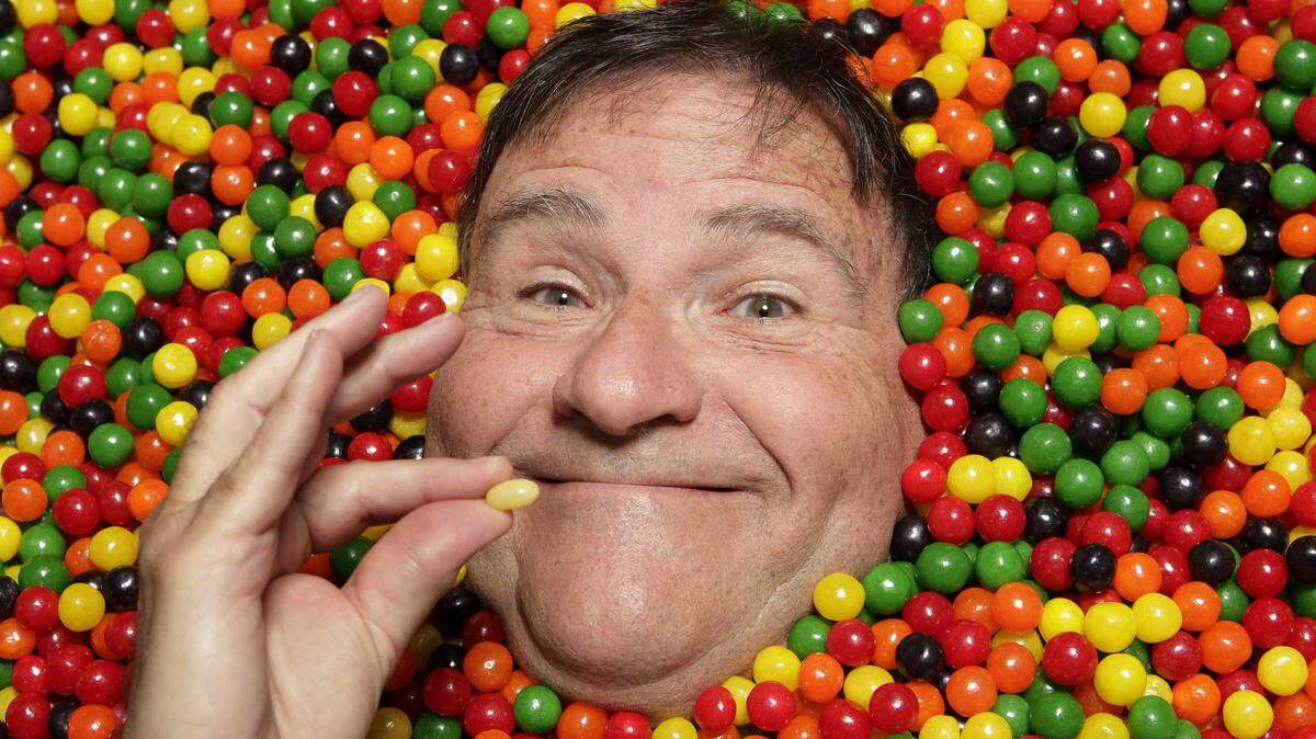 David Klein poses with candies in Covina in 2011. Jelly Belly is suing the Florida man who came up with the name for the product in 1976.
