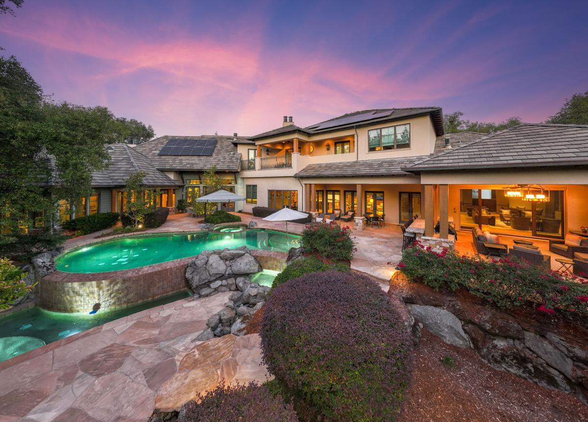 The zero-edge pool of the Granite Bay residence cascades down to a shallower level where the children can play.
