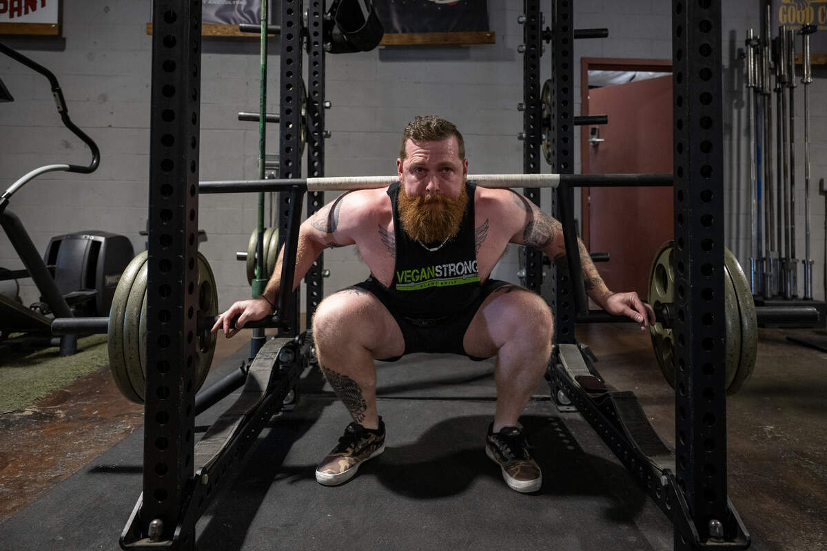 Powerlifter Nick Squires performs a squat, lifting over 300 pounds, at Third Street Barbell in Sacramento on Wednesday. Squires set six records and won a “best lifter” title at the U.S. Powerlifting Association’s Florida State Championships earlier this month.