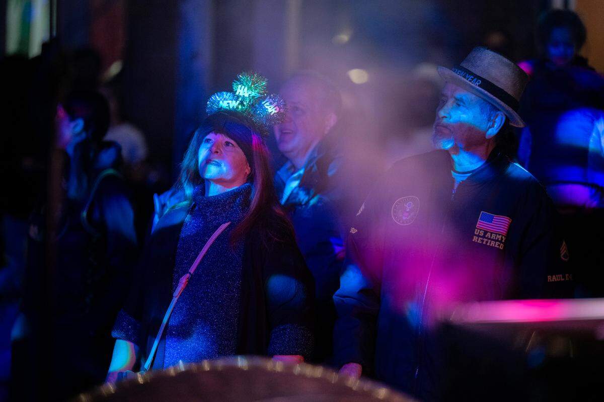 Jenny and Raul Enriquez of Marysville listen to music on K Street in Old Sacramento at the New Year’s Eve celebration on Tuesday night.