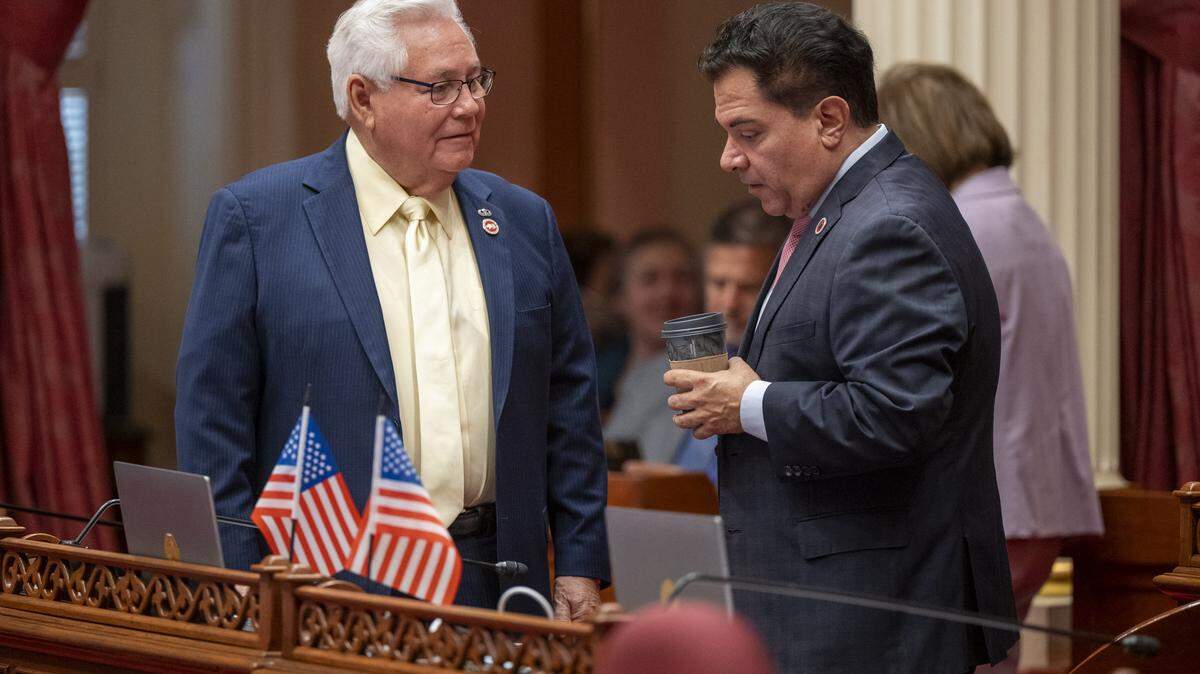 State Sens. Steve Padilla, D-Chula Vista, right, and Bob Archuleta, D-Pico Rivera, confer during a debate at the Capitol in Sacramento in June. Padilla is the author of Senate Bill 243, which attempts to protect children from harmful AI interactions.
