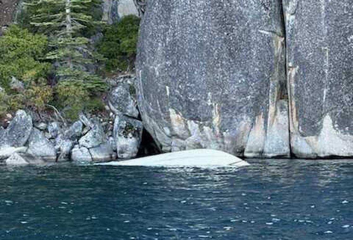An overturned 27-foot Chris-Craft floats partially submerged near D.L. Bliss State Park on Lake Tahoe on Saturday, June 21, 2025. The boat capsized in high winds and rough swells, leaving eight people dead, according to the U.S. Coast Guard.