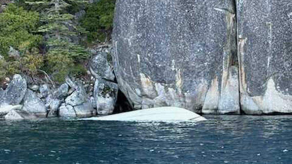 An overturned 27-foot Chris-Craft floats partially submerged near D.L. Bliss State Park on Lake Tahoe on Saturday, June 21, 2025. The boat capsized in high winds and rough swells, leaving six people dead and two others missing, according to the U.S. Coast Guard.