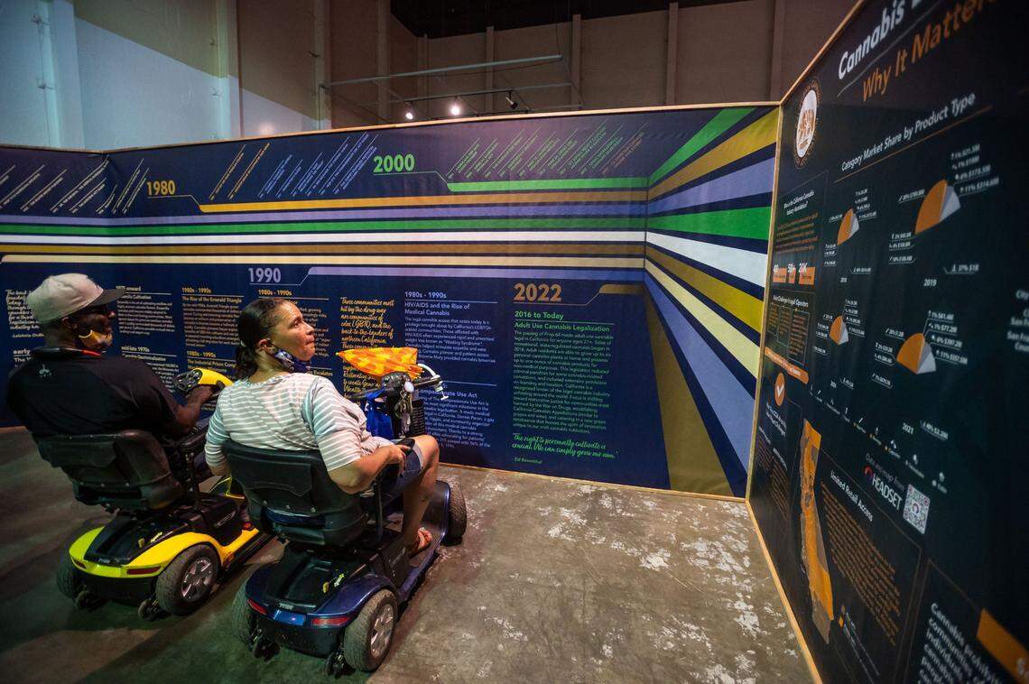 Cynthia Dorsey, right, and husband Daniel Dorsey, of Sacramento, look at displays about the history of cannabis while visiting the California State Fair’s inaugural Cannabis Awards exhibit Saturday at Cal Expo.