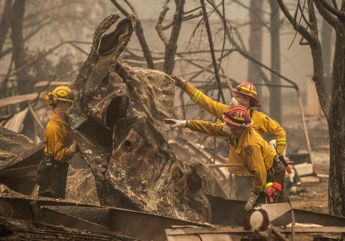 Search and rescue team search for victims of the Camp Fire at the Skyway Villa Mobile Home Park in Paradise. Damage claims have left state officials declaring a Merced County insurance company insolvent.
