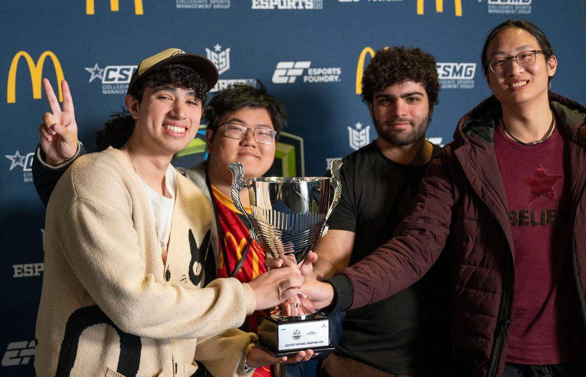 West Regional Champions in Super Smash Bros. from UC Riverside, Isaias Villanueva, left, aka “Willow,” holds the trophy with team mates Max Kang, Zayn Hamoui and Ken Huang, right, Sunday as Sacramento hosts its first major electronic gaming tournament at Cal Expo.