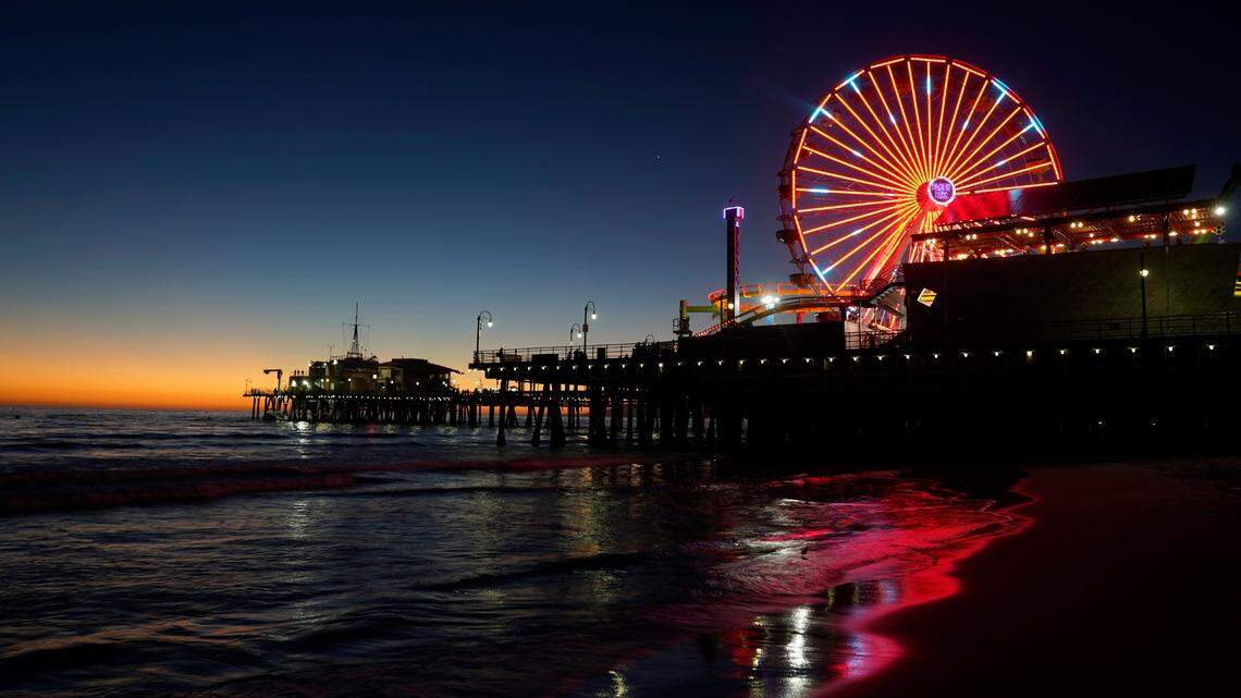 A ferris wheel illuminates the Santa Monica Pier in February, 2021. The city ranked the best for travelers and their pets.