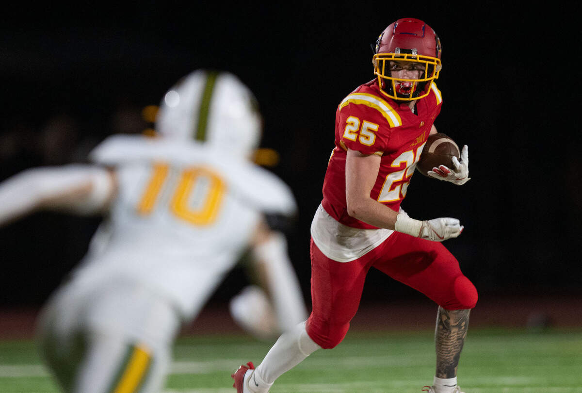 The Jesuit Marauders’ Alan Cordano (25) runs after a catch for a first down against the Rio Americano Raiders on Aug. 30 at Jesuit High School in Carmichael.
