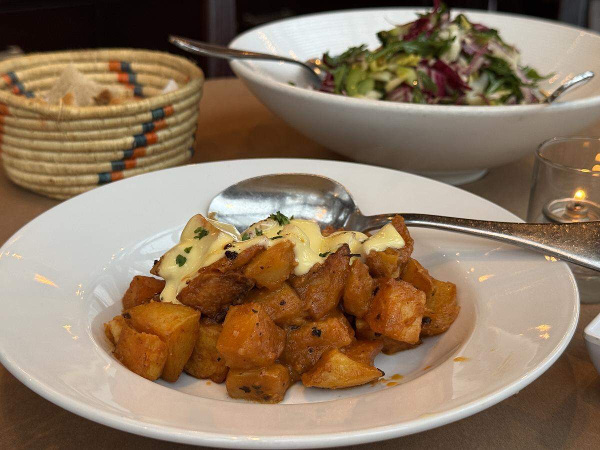 Aioli Bodega Espaniola serves patatas bravas and ensalada de Elsy, made with shredded celery, endives, radicchio, cucumber and roasted olives on Jan. 19, 2026.