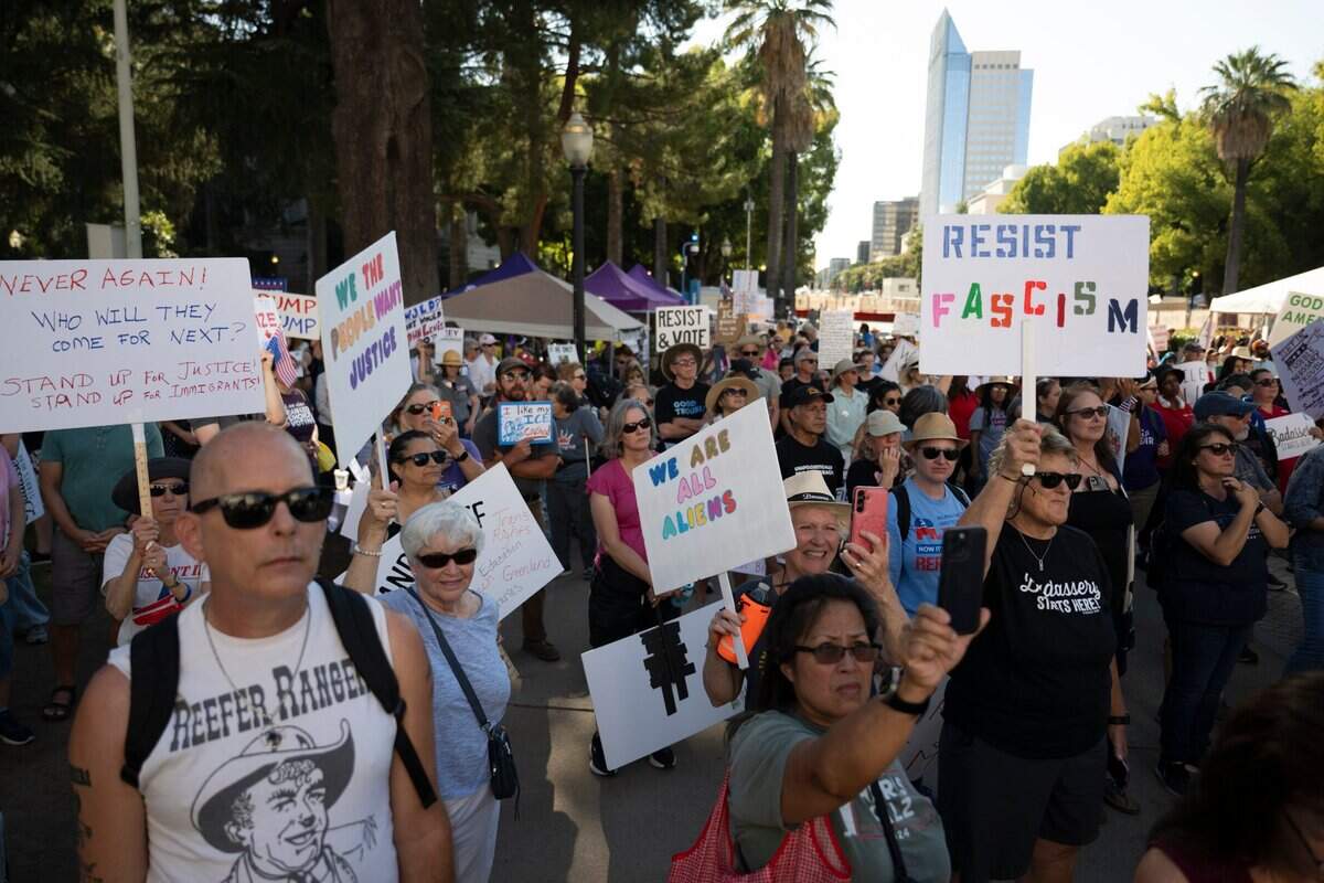 Demonstrators stand near the west steps of the state Capitol during the “Good Trouble” protest in Sacramento on Thursday. The protest, in opposition to President Donald Trump is named after former Rep. John Lewis and his legacy of activism.
