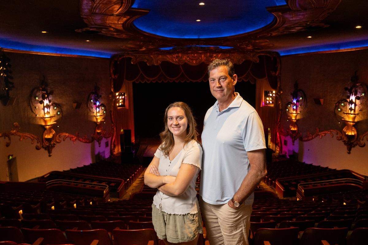 Owner Robert Emerick and his daughter, Ellie Emerick, stand in the historic Crest Theatre in Sacramento earlier this month.