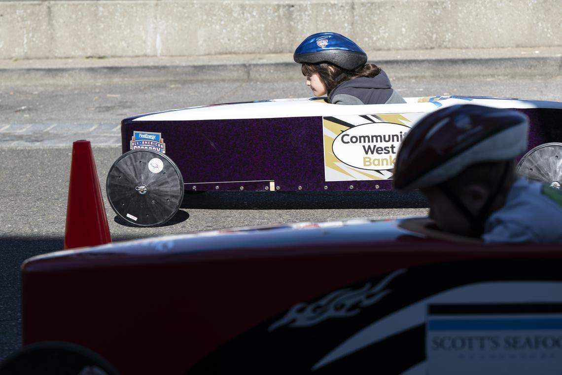 Ruby Anderson, 7, left, races against Ben Bakker, 8, right, during a stock class race as a part of the Folsom Historic District’s All-American Soap Box Derby in Folsom on Sunday, Oct. 5, 2025.