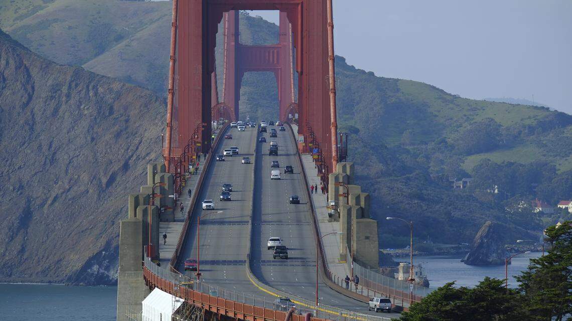 Little traffic is seen during the evening commute on the Golden Gate Bridge Friday, March 27, 2020, in San Francisco. The surge of coronavirus cases in California that health officials have warned was coming has arrived and will worsen, Gov. Gavin Newsom said Friday, while the mayor of Los Angeles warned that by early next week his city could see the kind of crush that has crippled New York.(AP Photo/Eric Risberg)