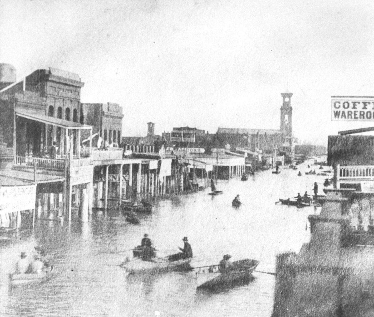 Boaters navigate K Street, as seen looking east from 4th Street, as floodwater submerge Sacramento buildings on Jan. 10, 1862.