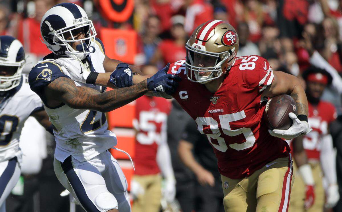 San Francisco 49ers tight end George Kittle (85) stiff-arms Los Angeles Rams cornerback Marcus Peters (22) during the first half of an NFL football game Sunday, Oct. 13, 2019, in Los Angeles.