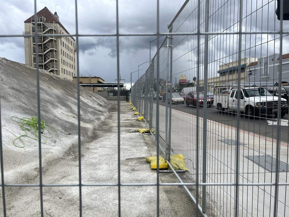 Late afternoon traffic waits at a light Thursday, March 13, 2025, beside what’s been dubbed Mount Marysville. It’s unclear whether the entombed remains of Hotel Marysville are hazardous or when the city will be able to clear them out.