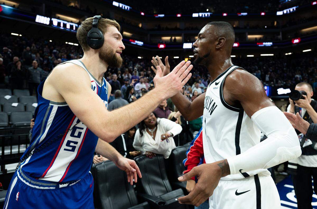 Brooklyn Nets forward Harry Giles III (14) congratulates Sacramento Kings forward Domantas Sabonis (10) after an NBA game at Golden 1 Center on Monday.