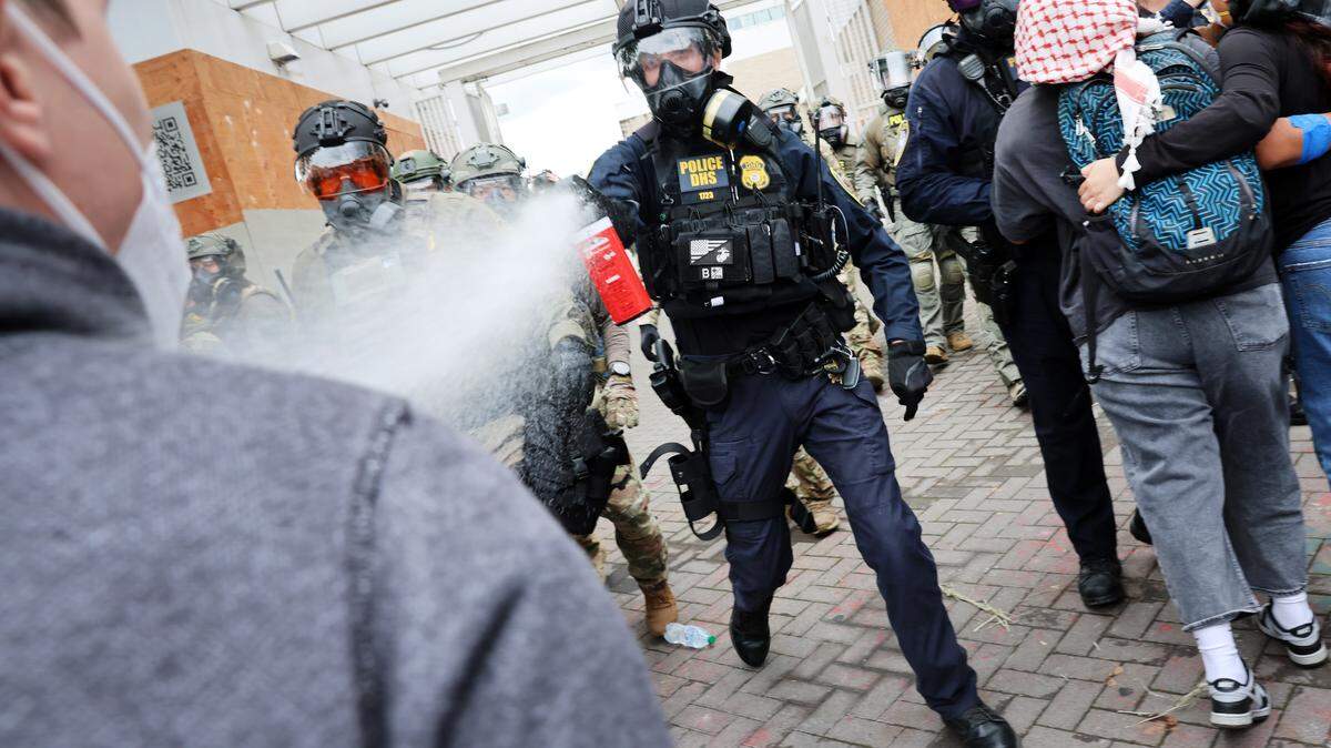 Federal agents, including members of the Department of Homeland Security, the Border Patrol, and police, clash with protesters outside a downtown U.S. Immigration and Customs Enforcement facility on Saturday, Oct. 4, 2025 in Portland, Ore. The facility has become a focal point of protests against the Trump administration and his announcement that he will be sending National Guard troops into the city.