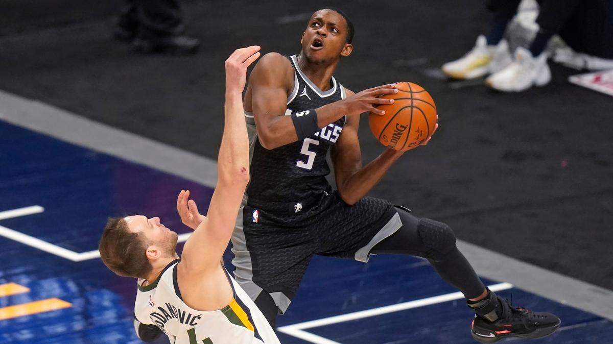 Utah Jazz forward Bojan Bogdanovic (44) defends against Sacramento Kings guard De’Aaron Fox (5) during the second half of an NBA basketball game Saturday, April 10, 2021, in in Salt Lake City. (AP Photo/Rick Bowmer)