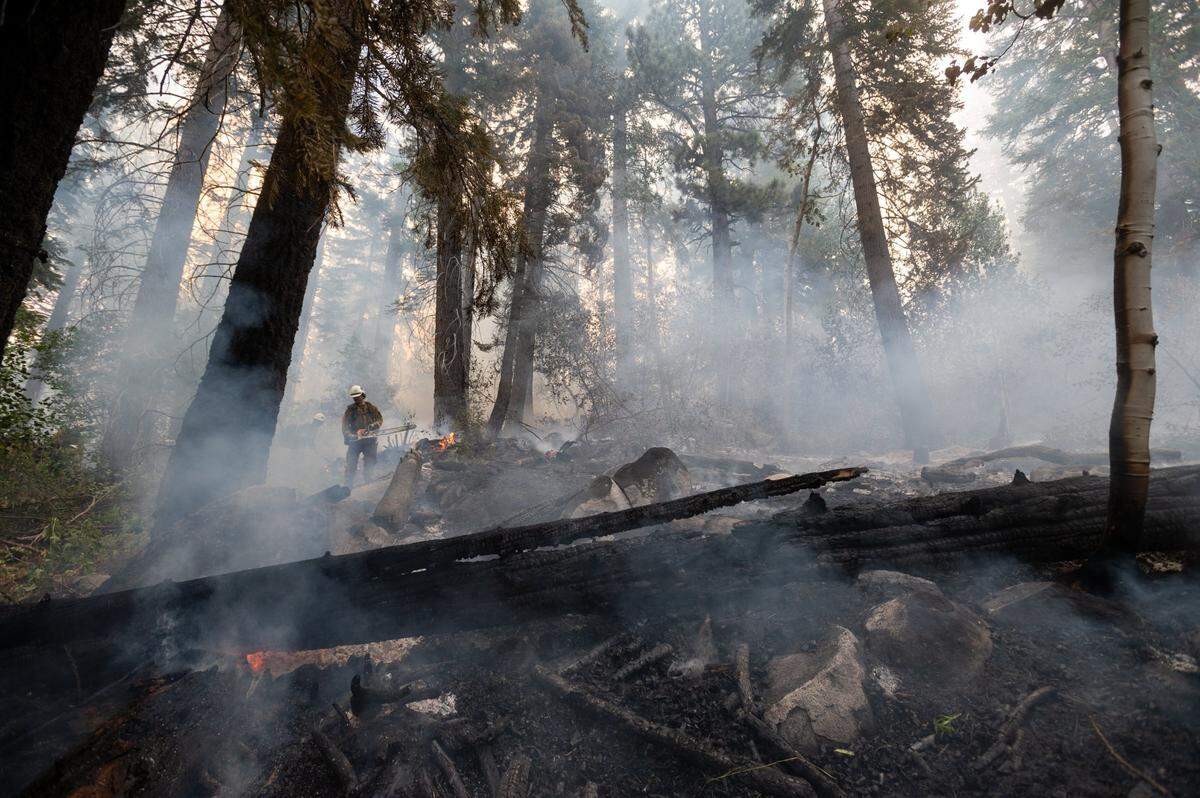 El Dorado County firefighters protect homes on Snowflake Drive in Christmas Valley on Tuesday, Aug. 31, 2021, as the Caldor Fire burned into the South Lake Tahoe Basin, down from Echo Summit.