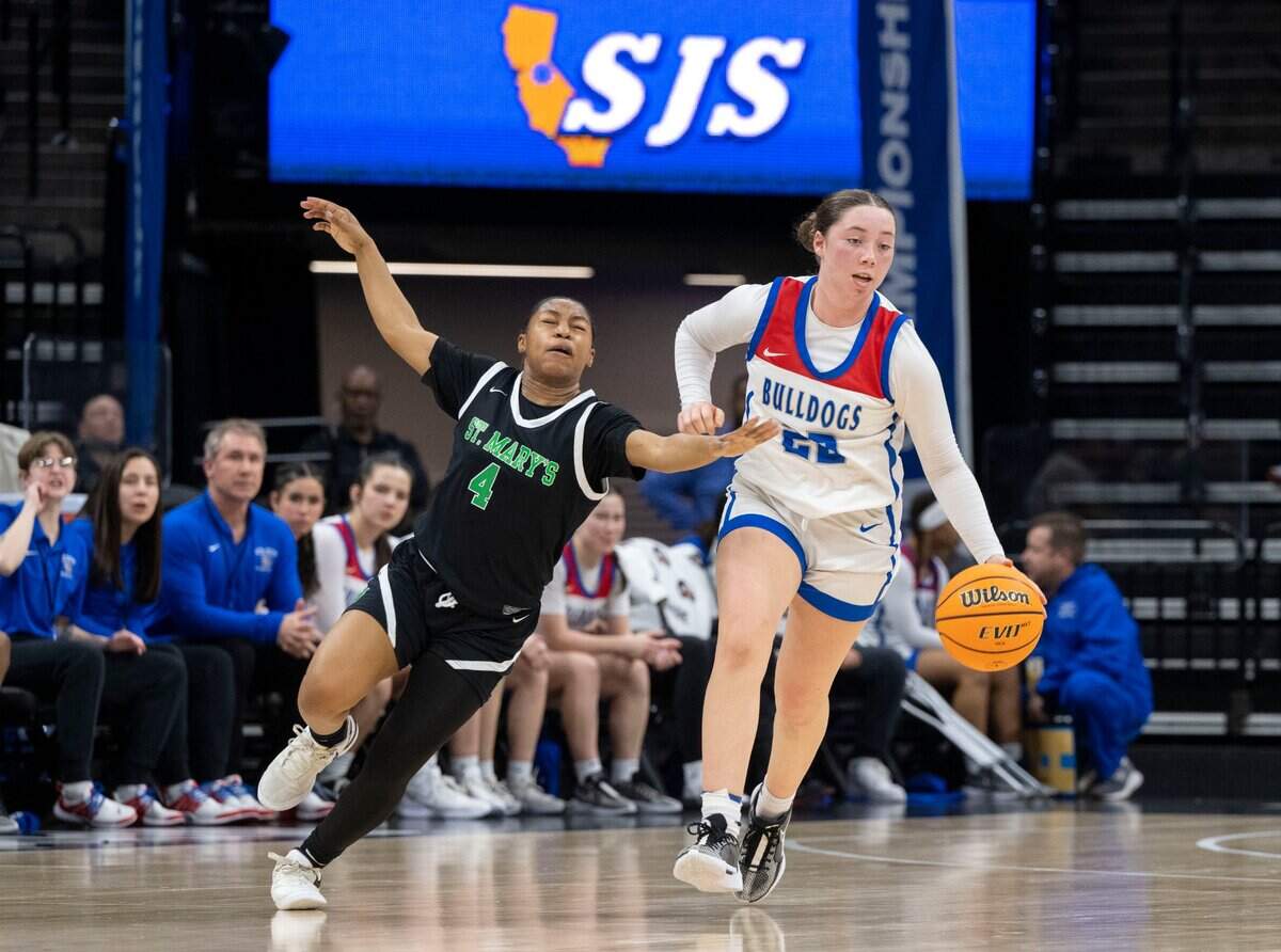 Folsom High School’s Dixie Mclanahan (22) keeps the ball away from St. Mary’s Nyah Buntun (4) during the CIF Sac-Joaquin Section Division I girls basketball section championship game on Wednesday, Feb. 21, 2024, at Golden 1 Center. St. Mary’s this season is a strong candidate for the No. 1 seed in the Division I playoffs, while Folsom has won five straight games entering Tuesday.