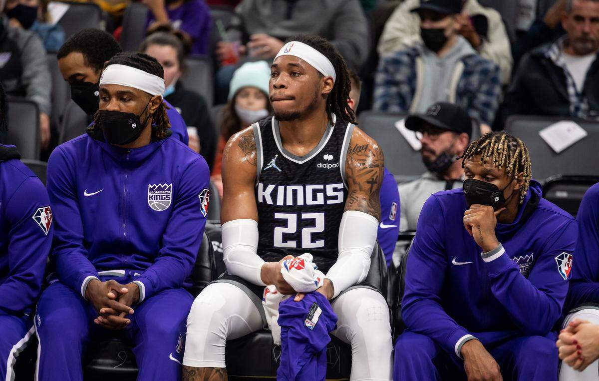 Sacramento Kings center Richaun Holmes (22), center, watches with teammates from the bench as the LA Clippers stay ahead of the Kings during the first half of the NBA basketball game Wednesday, Dec. 22, 2021, at Golden 1 Center in Sacramento.