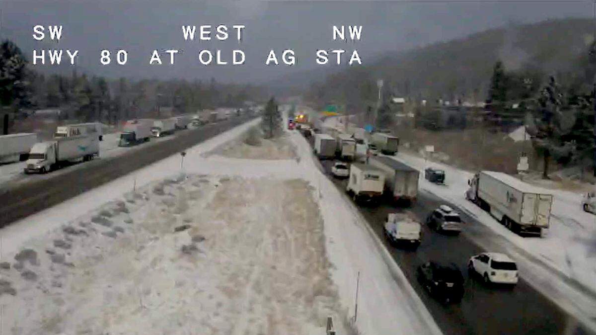 Vehicles crawl along Interstate 80, looking west, near the old agriculture inspection station near Truckee on Thursday, Dec. 12, 2024. Caltrans issued chain controls for I-80, as well as Highway 50, amid a quick-moving snow storm blanketing the Sierra.