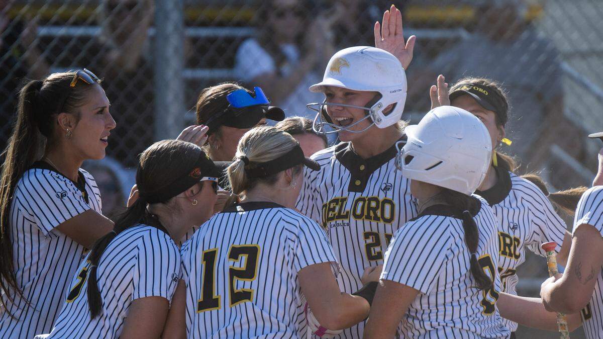 The Del Oro Golden Eagles' Emma Johnson is surrounded by teammates after hitting a two-run home run in the bottom of the fifth inning to even the score against the Rocklin Thunder on Tuesday in Loomis.